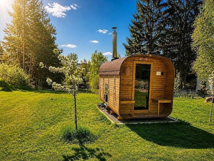 Finnish sauna in a wooden wagon on the meadow by the yurts